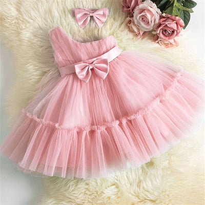Robe princesse bébé rose pastel avec plusieurs couches de tulle et nœud en ruban