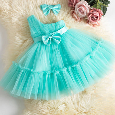 Robe princesse bébé rose pastel avec plusieurs couches de tulle et nœud en ruban