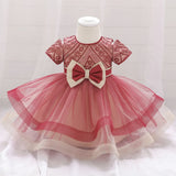 Robe princesse bébé rouge foncé avec motifs floraux et nœud crème