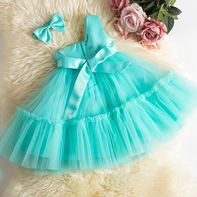 Robe princesse bébé rose pastel avec plusieurs couches de tulle et nœud en ruban