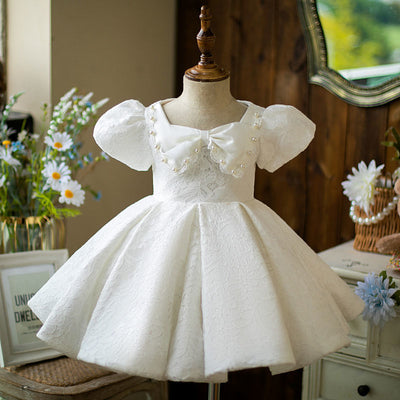 Robe cérémonie fille blanche en dentelle avec manches bouffantes et nœud à perles