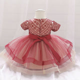 Robe princesse bébé rouge foncé avec motifs floraux et nœud crème
