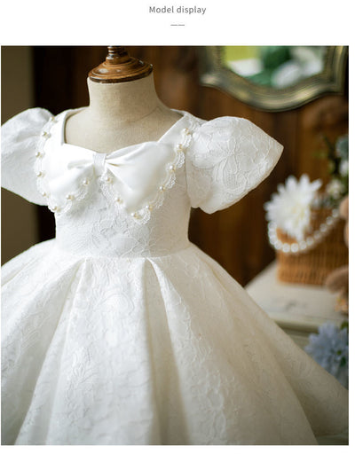 Robe cérémonie fille blanche en dentelle avec manches bouffantes et nœud à perles