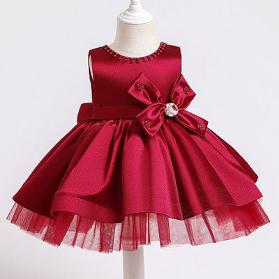 Robe princesse bébé rose avec nœud décoratif et perles