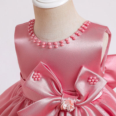 Robe princesse bébé rose avec nœud décoratif et perles