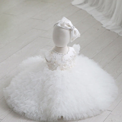 Robe baptême bébé fille blanche avec broderies florales et volants en tulle